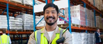 A person in a business setting, using a laptop, with a blurred background.