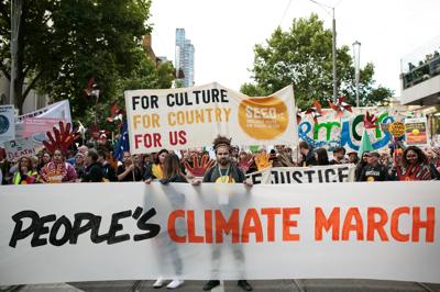 People marching, holding signs, Climate March 2015.