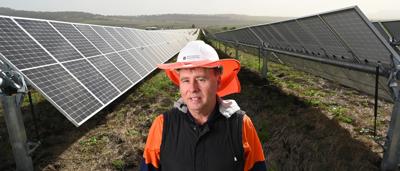 Man in hard hat at solar farm, Queensland.