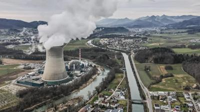 Header image: Nuclear power plant cooling towers against a blue sky.