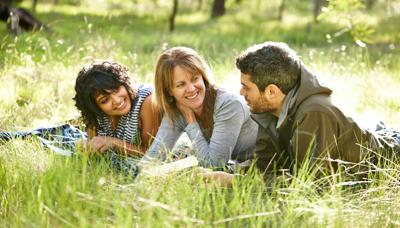 Woman smiling, headshot, outdoors, natural light, professional attire.