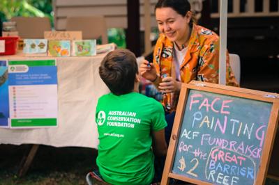 The Gole family and friends fundraise at their local market every month to help ACF stop the Carmichael coal mine.
