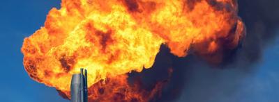 Gas flare emitting flames into the night sky.