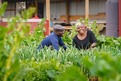People at a table, food, outdoor setting, sunny day.