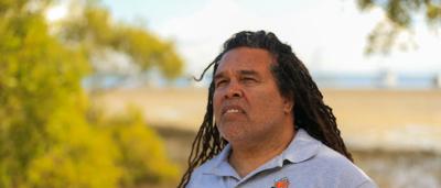 Man standing near water, wetland, development threat, Straddie Adventures owner.