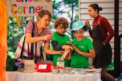 Family fundraising at market, ACF support, anti-coal mine campaign.