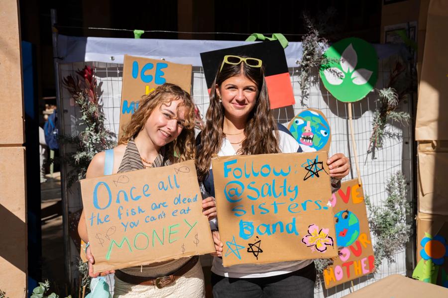 Festival-goers with handmade climate signs