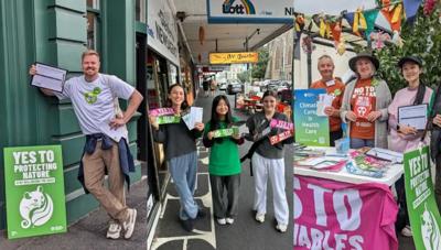 A vibrant graphic with text and shapes, featuring a stylized tree and colorful elements.