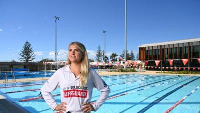 Woman with dark hair, smiling, in front of a blurred background.