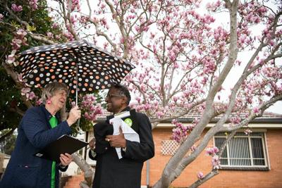 People door knocking, smiling, sunny day.