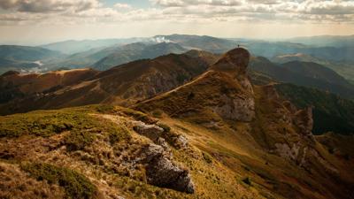 Mountain range with snow-capped peaks under a blue sky.