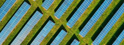 Solar panels on a rooftop, blue sky background.