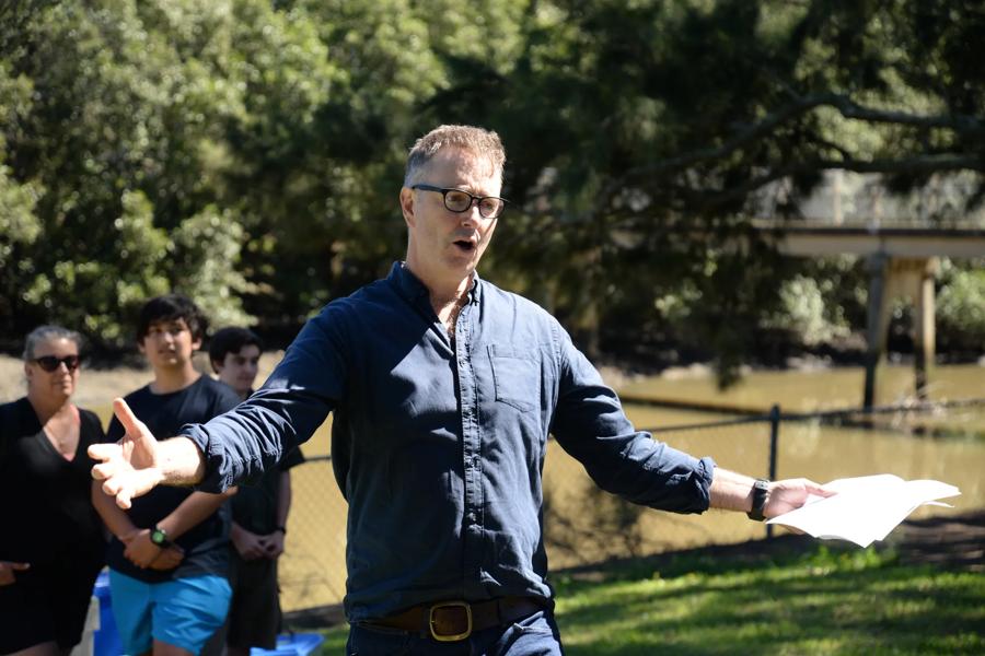 Paul Sinclair speaking, mid-gesture, at a nature laws community barbeque in Sydney, 2019