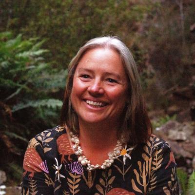Woman, profile, smiling, dark hair, square headshot.