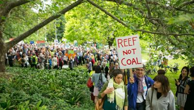 Header image: People holding signs, reef in background, text "Reef Not Coal".