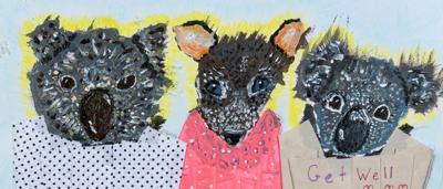 Black and white photo, woman with paint, holding art, outdoors, forest background.