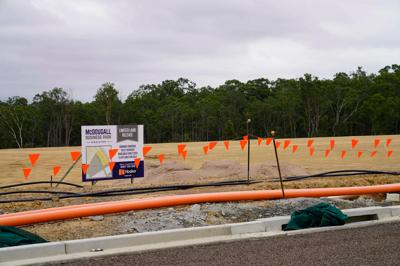 Industrial estate header image: buildings, road, sky, trees.