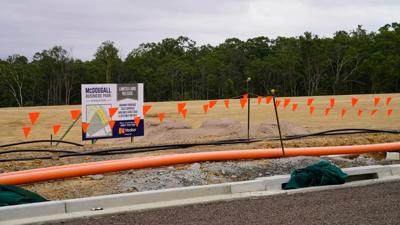 Industrial estate header image: buildings, road, sky, trees.