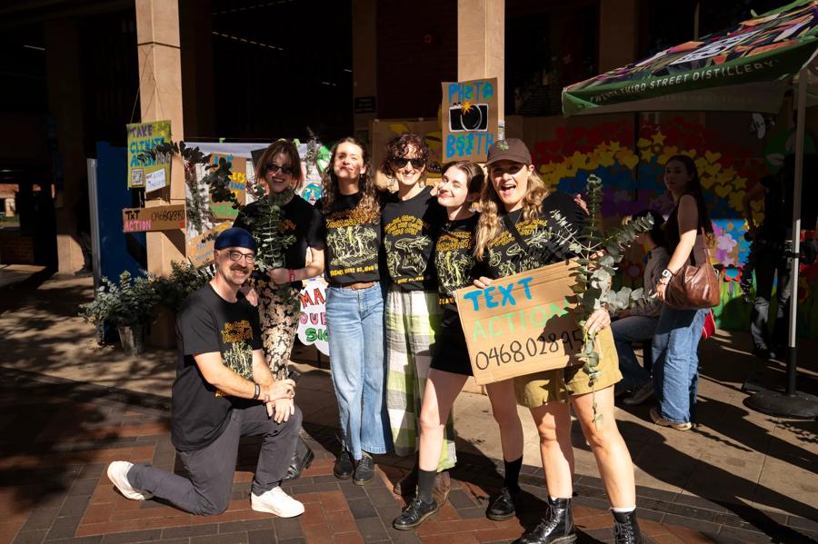 Some of the ACF team holding signs and eucalyptus stems