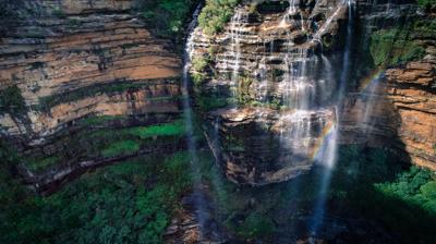 Scenic view: Wentworth Falls, Katoomba. Mountains, trees, waterfall, blue sky.