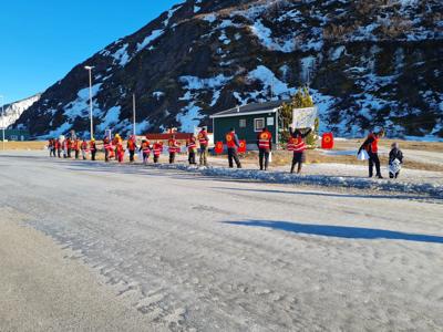 Greenland landscape, icebergs, mountains, blue water, cloudy sky.