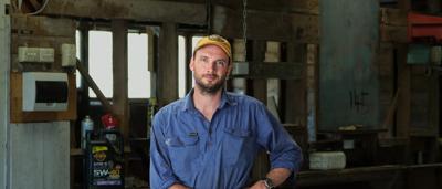 Two men, Paul and Marty, smiling, standing outdoors, trees in background.