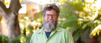 Man in a suit, smiling, headshot, Brendan Sydes.