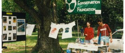 ACF stall with banner, people, and merchandise displayed.