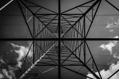 Header image: Transmission tower with a bird, blue sky.