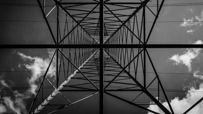 Header image: Transmission tower with a bird, blue sky.