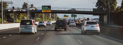 Hallam, Victoria traffic scene. Cars on road, overcast sky.