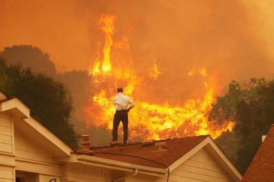 California wildfire scene with smoke and flames.
