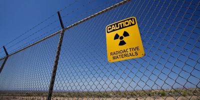 Nukes sign with a red cross, black background.