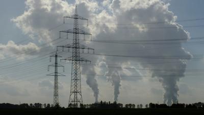 Smoke billowing near power lines.