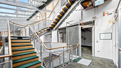 Victorian building, 60 Leicester Street, Carlton. Red brick facade, arched windows, ornate details.