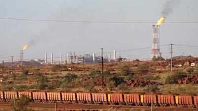 Header image: Burrup Hub, industrial landscape, sunset, smoke stacks, and ocean.