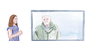 A group of people in a classroom setting, with a whiteboard in the background.