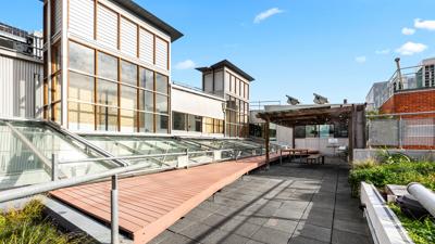 Victorian building, Leicester Street, Carlton. Red brick facade, arched windows, ornate details, street view.