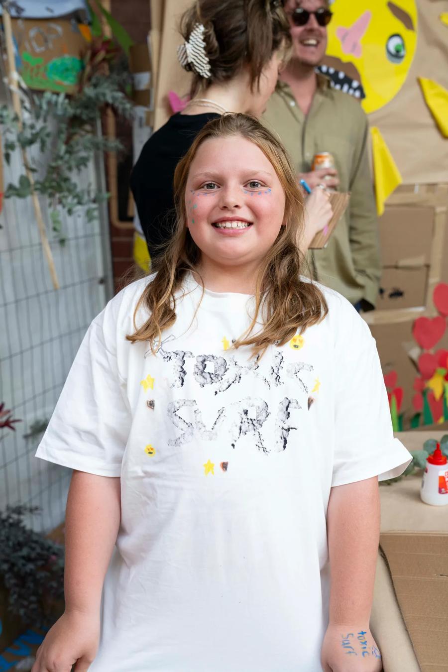 A young festival-goer in a hand-decorated Toxic Surf t-shirt