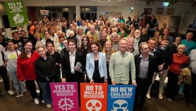 Sticker sheet with various colorful designs, including text and illustrations.