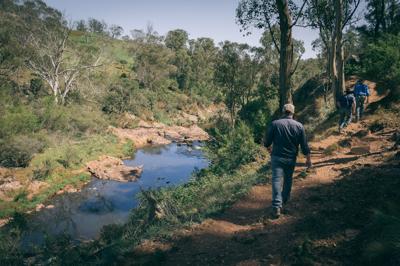 Platy Project event at Wilmot Farm: people, water, trees, and signage.