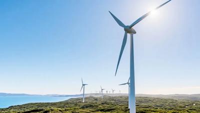 Header image: Wind turbines and solar panels on a sunny day, representing renewable energy.