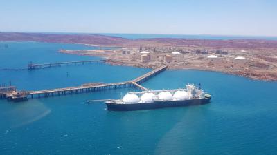 Ship sailing on water, blue sky, white clouds.