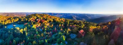 Panorama of Mount Wilson town in autumn, Blue Mountains, Australia. Colorful trees, houses, and sky.