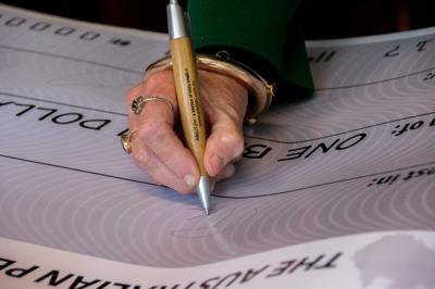 People handing over a large petition, text visible, ACF logo, crowd.