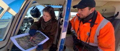 Kim and Nat looking at a map of cleared land.