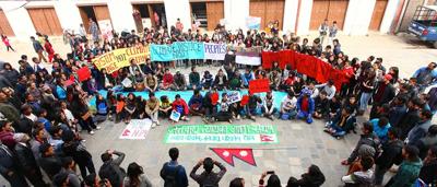 Woman in white coat, holding a clipboard, smiling, looking at camera.