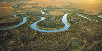 A drone shot for a curved river running in forest