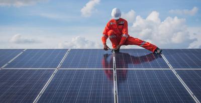 Solar panels on a rooftop, blue sky background.