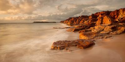 Kimberley landscape, red cliffs, blue sky, green vegetation.